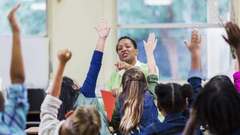 image of kids raising their hands at school - vnet education cic